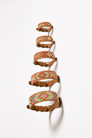 Set of five decorative dog collars with tribal artisanal patterns on a white background